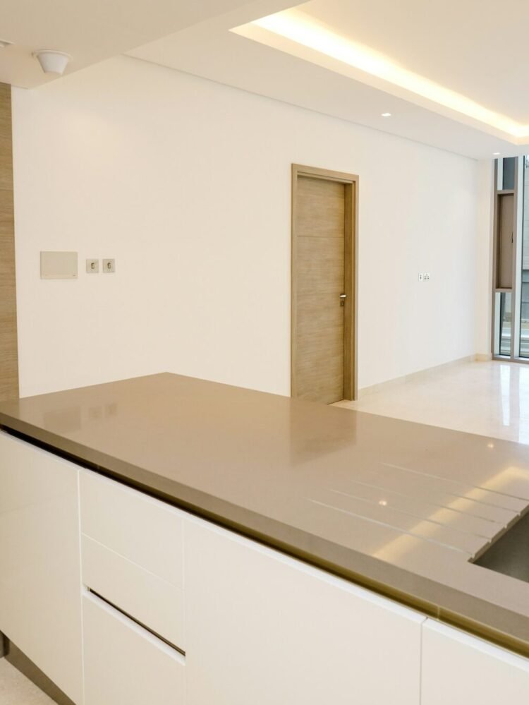 A kitchen with a sink and a large window